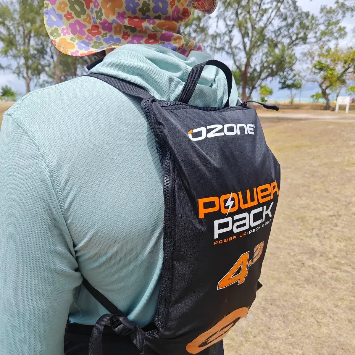 A 4.3m PowerPack packed into its black Ozone rucksack and worn on a rider's back, the bag branded OZONE POWER PACK, POWER UP PACK DOWN and 4.3