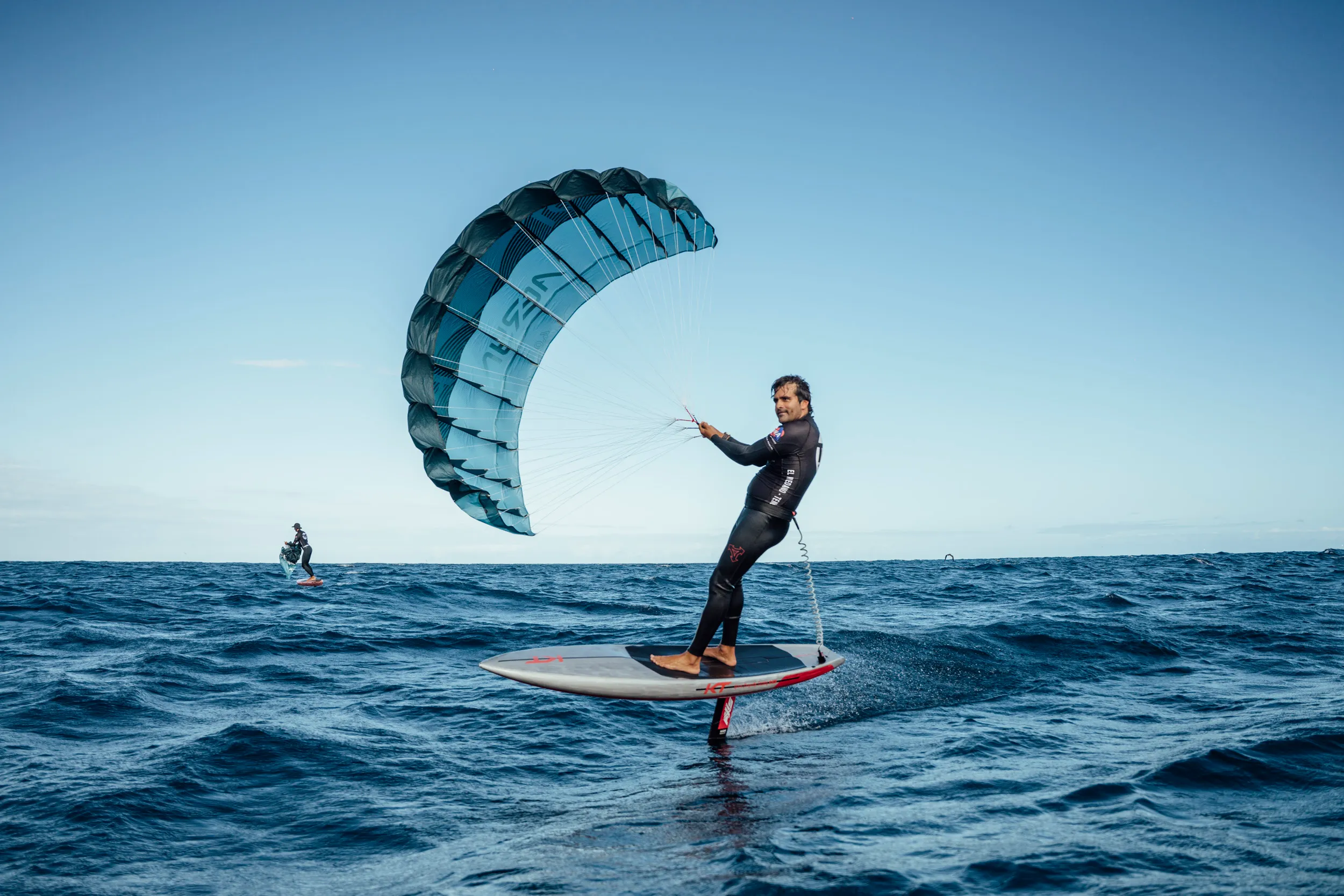 Aeryn P1 Pocket Wing rider foiling along a volcanic coastline