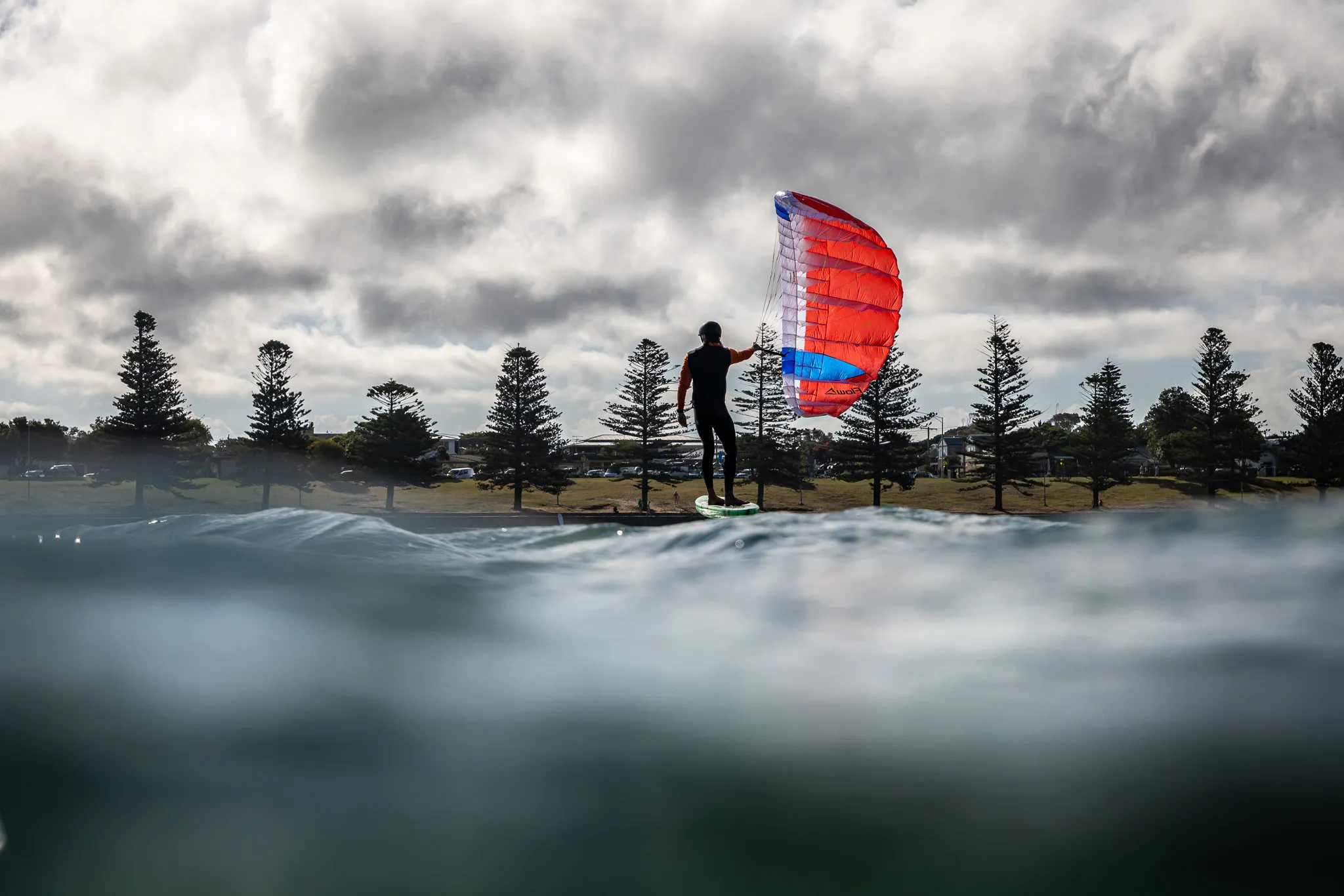 Parawing foiler riding on flat water during a brand review session
